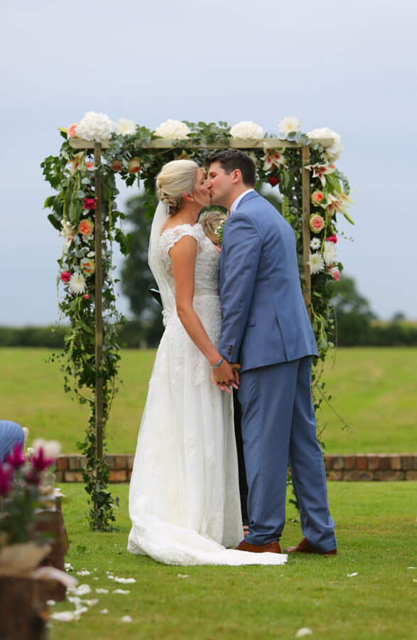 Sealed with a kiss. Heather and Dan's ceremony on the Manor Lawn. Photography by Simon Stock.